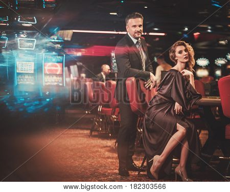 Well-dressed couple in a luxury casino interior