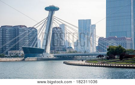 Tianjin, China - Nov 1, 2016: Chingfen Bridge spans across the Haihe River. Backgropund buildings in contrasting modern and old architectural style. Viewed from Tianjin Railway Station.