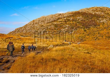 DALSNUTEN NORWAY - OCTOBER 12 2016: Unidentified group of tourists on hiking trail to Dalsnuten Top a famous tourist attraction in Norway.