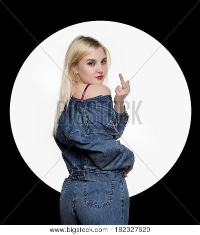 back view of young woman in denim jaket and jeans show middle finger, fuck you off sign on white background. indecent lifestyle concept. White circle on a black background