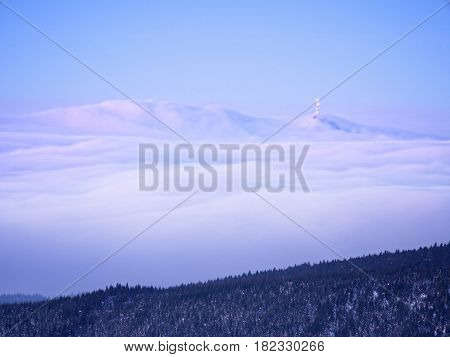 Far Mountain Peak With Observatory Above Creamy Mist.