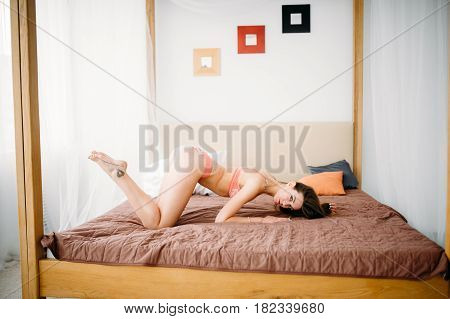 Girl In Flower Panties On The Bed. She Took A Sexy Pose, Showing Off Her Naked Body Beautiful Ass. M