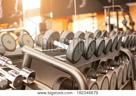 Rows of dumbbells in the gym with hign contrast and monochrome color tone