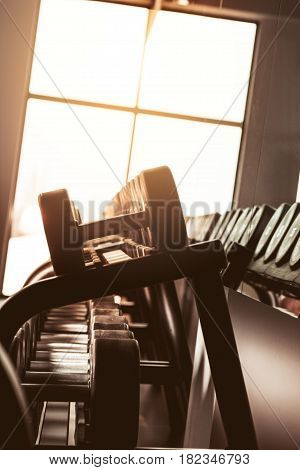 Rows of dumbbells in the gym with hign contrast and monochrome color tone