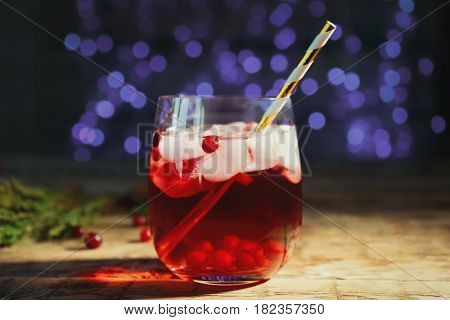 Glass of delicious wine spritzer on blurred lights background