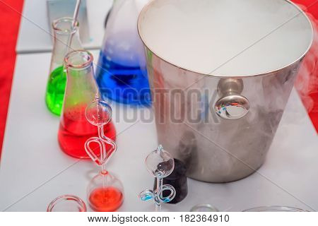 Laboratory expreriment with test-tubes with colored chemical reagents, retorts and flasks