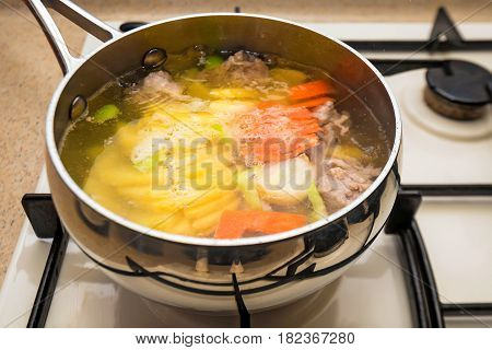 Close-up of preparing healthy dietic soup on gas stove
