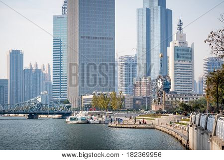 Tianjin, China - Nov 1, 2016: Commercial skyline across the Haihe River. Buildings in modern architectural style. Image includes the Century Clock.