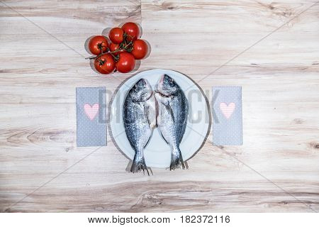 Two grilled seabreams on a plate ready for the barbecue