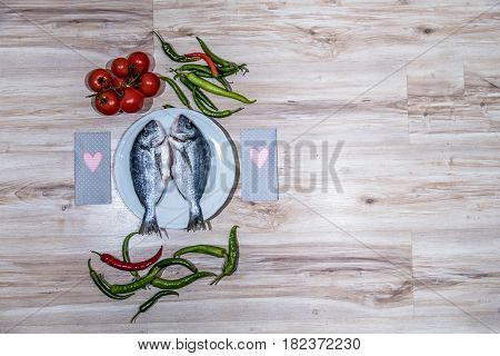 Two grilled seabreams on a plate ready for the barbecue