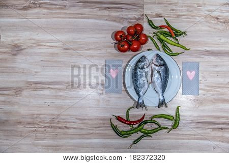 Two grilled seabreams on a plate ready for the barbecue
