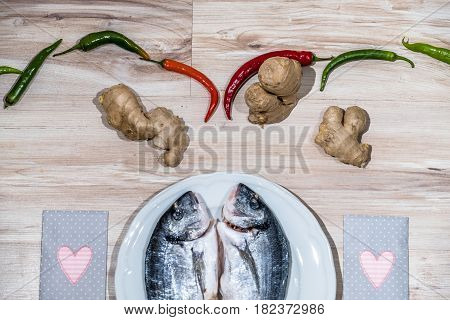Two grilled seabreams on a plate ready for the barbecue