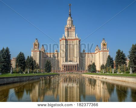 Lomonosov Moscow state university (or MSU) at summer morning against clear blue sky, reflected in a pond. This photo is HDR image, combined from 3 different exposures.