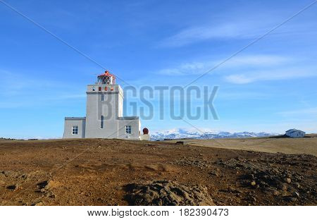 Beautiful snow capped mountains behind Dyrholaey Lighthouse in Iceland.