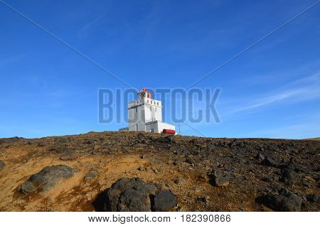 Dyrholaey Lighthouse on the top of the sea cliffs in Iceland.