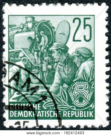GERMANY - CIRCA 1953: A stamp printed in Germany (GDR) is dedicated to the five-year plan shows the Locomotive building circa 1953