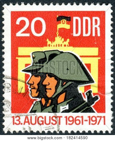 GERMANY - CIRCA 1971: A stamp printed in Germany (GDR) dedicated to 10 years of Berlin Wall shows the Militiaman Soldier and Brandenburg Gate circa 1971