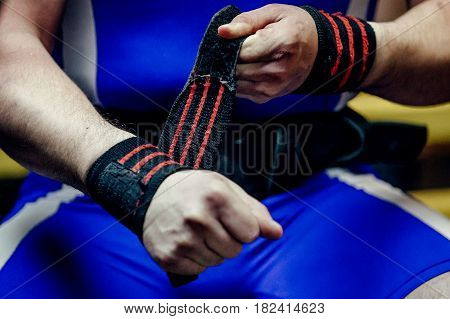 closeup of hands athlete powerlifter in wristbands