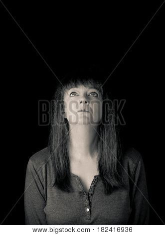 Portrait Of A Mature Woman Looking Up. Low Key.