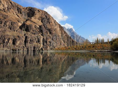 Golden Autumn Reflection Landscape Of Khalti Lake In the Tehsil Gupis of Ghizer District, Northern Pakistan