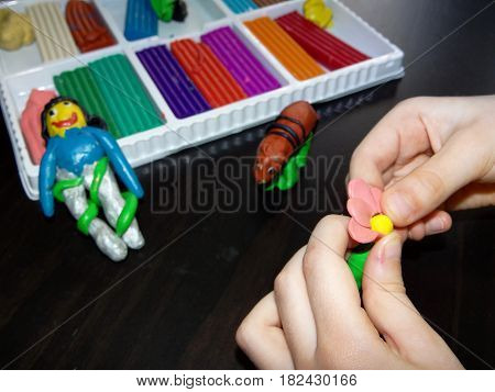 original figurines from colored clay molded child