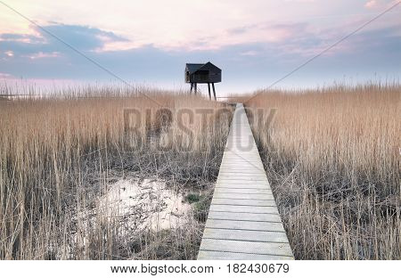 wooden path to bird observation tower on coast