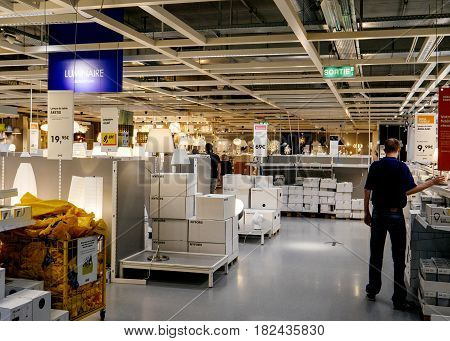 PARIS FRANCE - APR 10 2017: Man buying lighting led lamps IKEA Shopping furniture store in Paris France. Being founded in Sweden in 1943 IKEA is the world's largest furniture retailer.