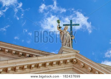 Bottom view of The statue at the San Redentore church at the isle Giudecca in Venice, Italy with blye colorful sky and white clouds