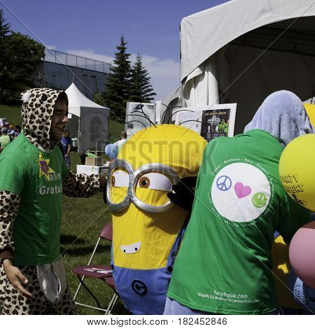 Laval, Quebec - June 14, 2015 - Square view of a volunteer laughing with a costumed Minion at the 
