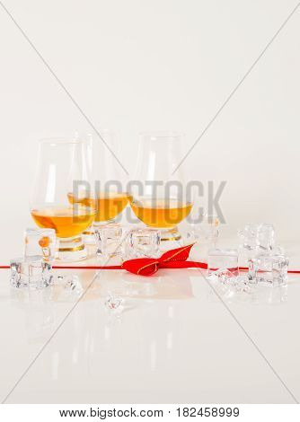 Set Of Single Malt Tasting Glasses, Single Malt Whisky In A Glasses, White Background, Red Bow