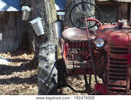 very old tractor red rusty farming machine at maple grove