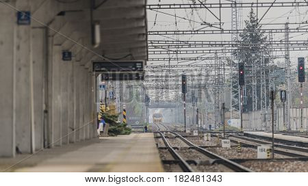 Train in Hodonin station in dark fog spring morning