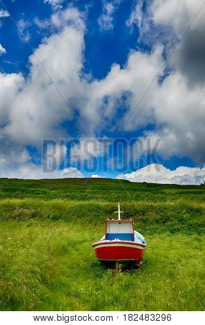 Spanish destination, Galicia, little boat on a green meadov, retirement concept image