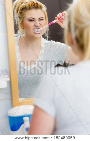 Woman Brushing Cleaning Teeth In Bathroom