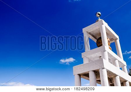 tower of monk Buddist in temple, Thailand, on a bright sunny day with blue sky and copy space for text