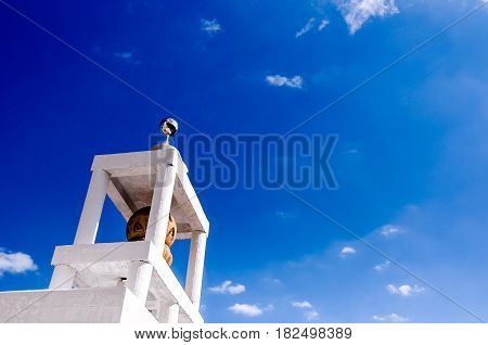 tower of monk Buddist in temple, Thailand, on a bright sunny day with blue sky and copy space for text
