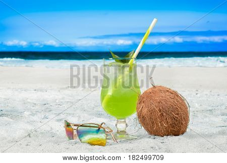 Glass of fresh cocktail on the beach. Summer Vacation at Paradise