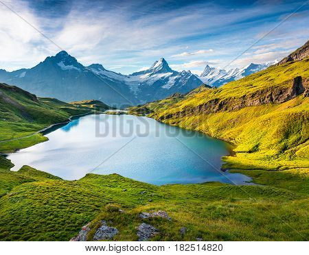 Wetterhorn and Wellhorn peaks over Bachsee lake. Colorful summer scene in Bernese Oberland Alps Grindelwald location Innertkirchen Switzerland Europe.