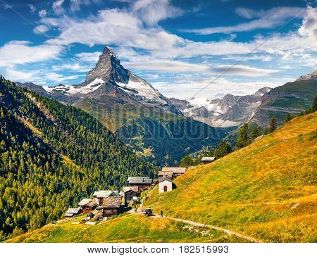 Sunny summer morning in Zermatt village with Matterhorn (Monte Cervino Mont Cervin) peak on backgroud. Beautiful outdoor scene in Swiss Alps Valais canton Switzerland Europe.