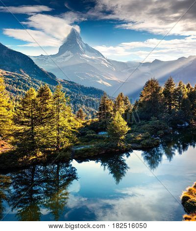 Colorful summer morning on the Grindjisee lake. Reflection of Matterhorn (Monte Cervino Mont Cervin) peak in the watter surface. Beautiful outdoor scene in Swiss Alps Zermatt location Valais canton Switzerland Europe.