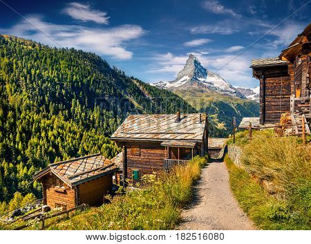 Sunny summer morning in Zermatt village with Matterhorn (Monte Cervino Mont Cervin) peak on backgroud. Beautiful outdoor scene in Swiss Alps Valais canton Switzerland Europe.