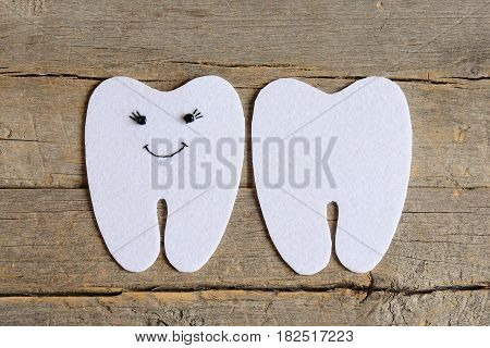 How to sew a felt tooth fairy. Step. Guide. Cut felt details to create a felt tooth fairy. On one side embroidered with black thread and beads eyes and mouth. Easy sewing project and crafts. Top view