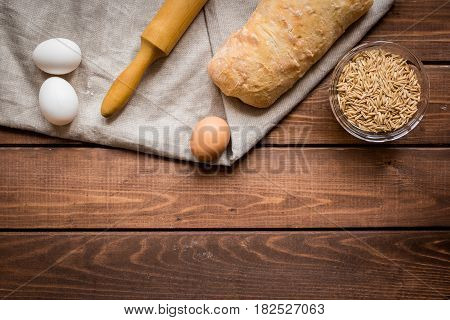 Baking fresh homemade bread on wooden kitchen table background top view moke up