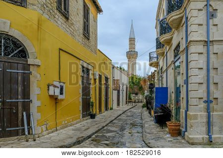 Mosque with minaret in street scene in old town Limassol.