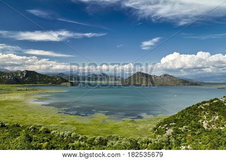Panoramic view of Skadar lake bay at the Montenegro part travel destination. A sunny day in the Skadar lake with mountains is a national park and one of the most beautiful places on Montenegro, Europe