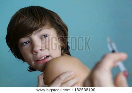 Teenager Boy In Doctors Cabinet Undergo Vaccination Afraid