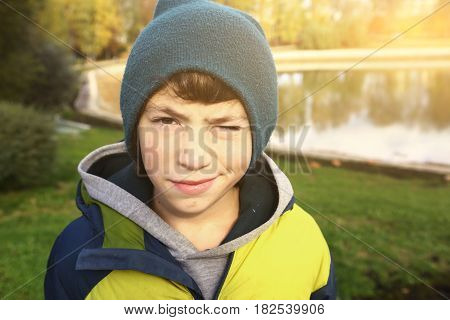 Preteen Boy In Knitted Hat And Down Jacket