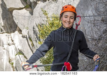 Woman hanging on Tibetan bridge climbing up to the hill. Horizontal outdoors shot