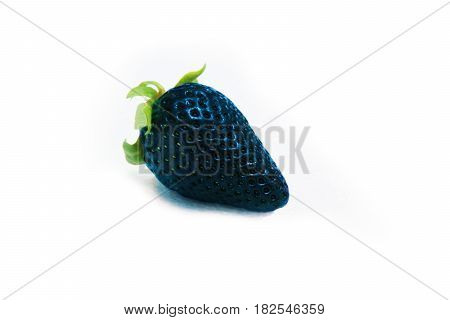 Different than the rest alone blue strawberry.Concept for genetically modified food