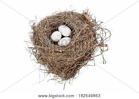 Isolated bird nest with spotted eggs over white background. Image shot from above with copy space.